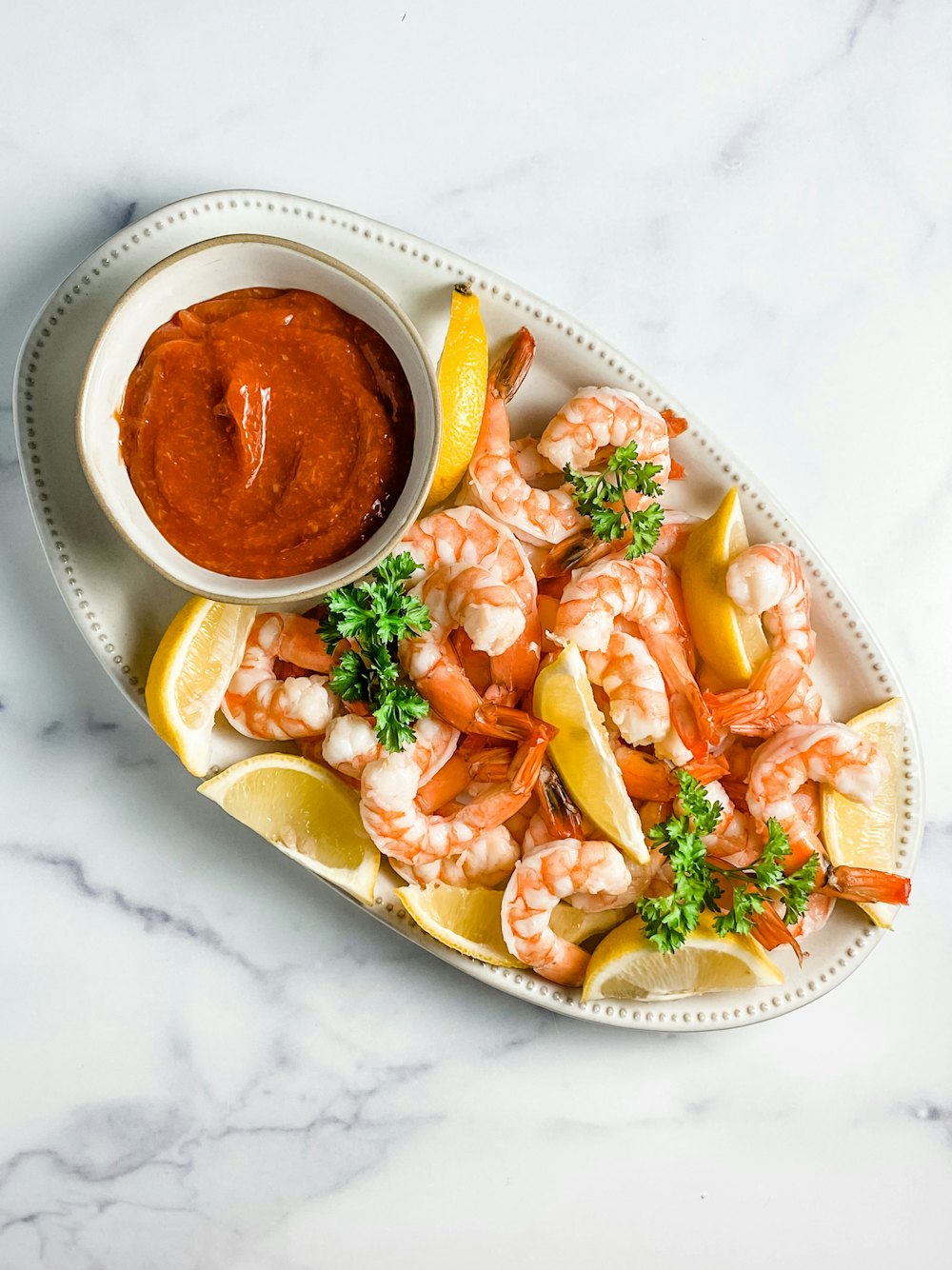 Stock photo of a shrimp cocktail with lemon and cocktail sauce